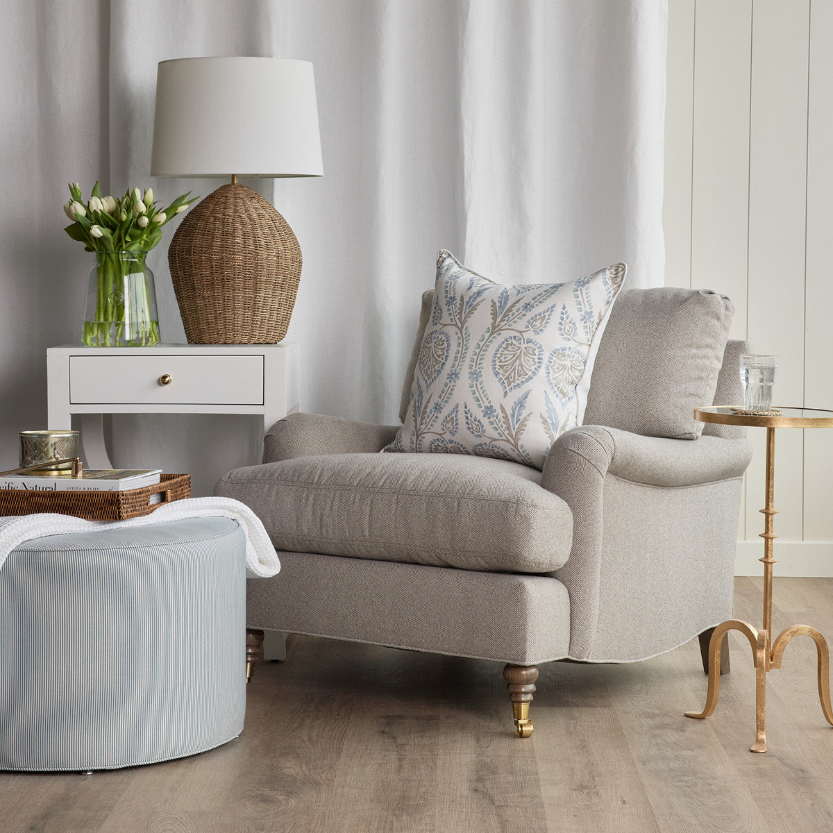 Kate Ottoman styled with rattan tray and white throw. Styled view.