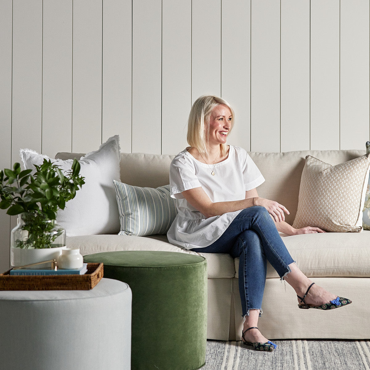 Kate Ottoman styled with a green ottoman, neutral sofa and spring decor. Styled view.