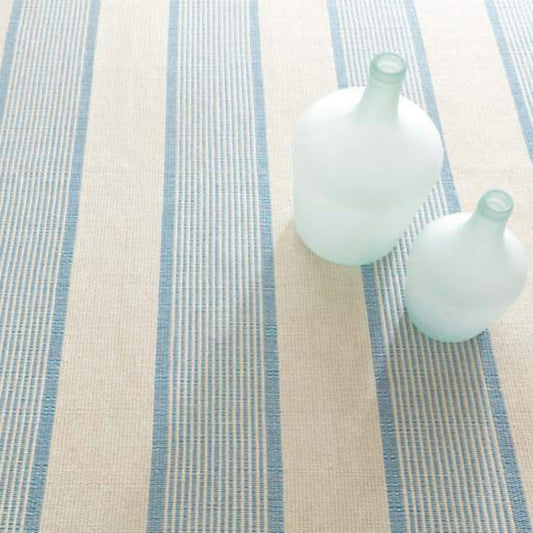La Mirada Asiatic Blue Woven Cotton Rug styled under blue vases. Styled view.