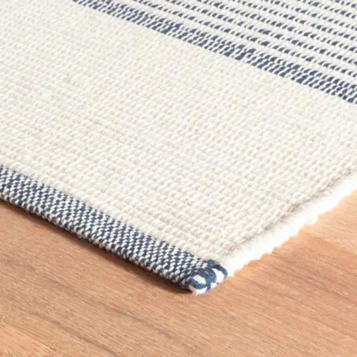 La Mirada Navy Woven Cotton Rug corner detail. Close-up detail view.
