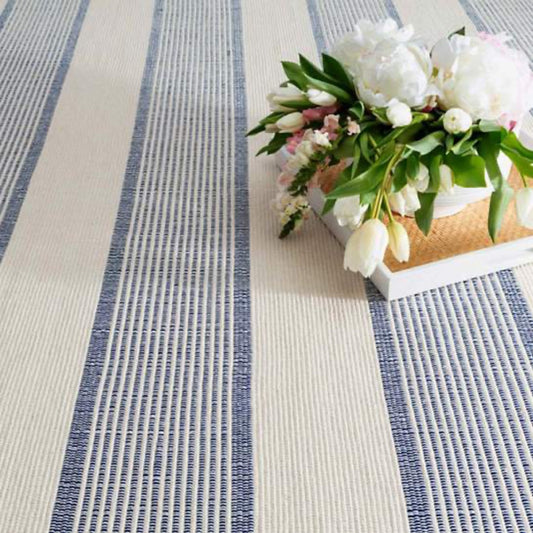 La Mirada Navy Woven Cotton Rug under a tray with florals. Styled view.
