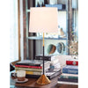 Parasol Table Lamp styled on a wood table with books. Styled view.