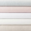 Stack of lush linen duvet covers. Styled view.
