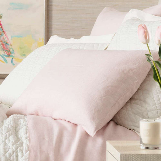 Lush Linen Slipper Pink Sham styled with white bedding. Styled view.