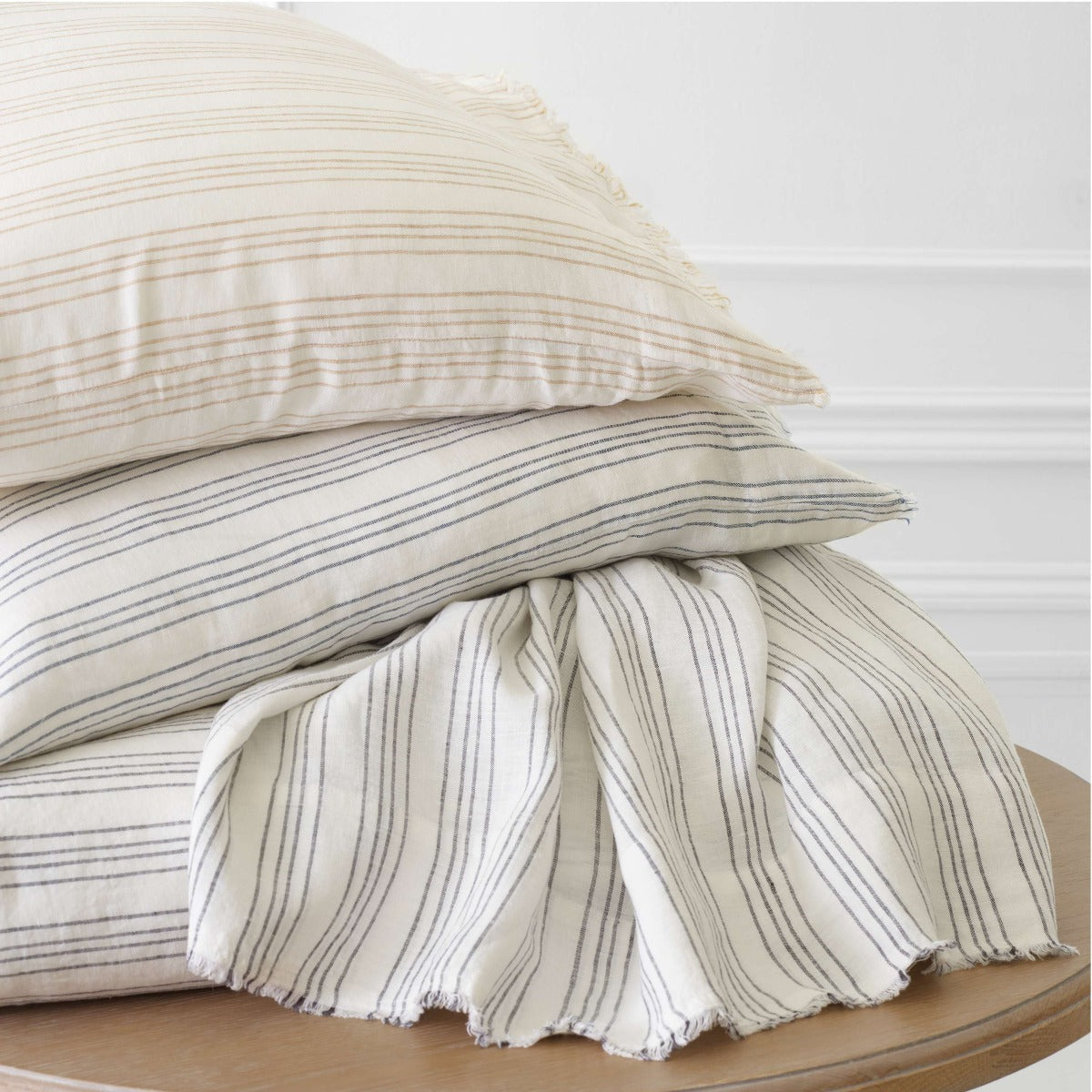 Lush Linen Stripe Slate Blue Duvet Cover styled with pillow inserts. Styled view.