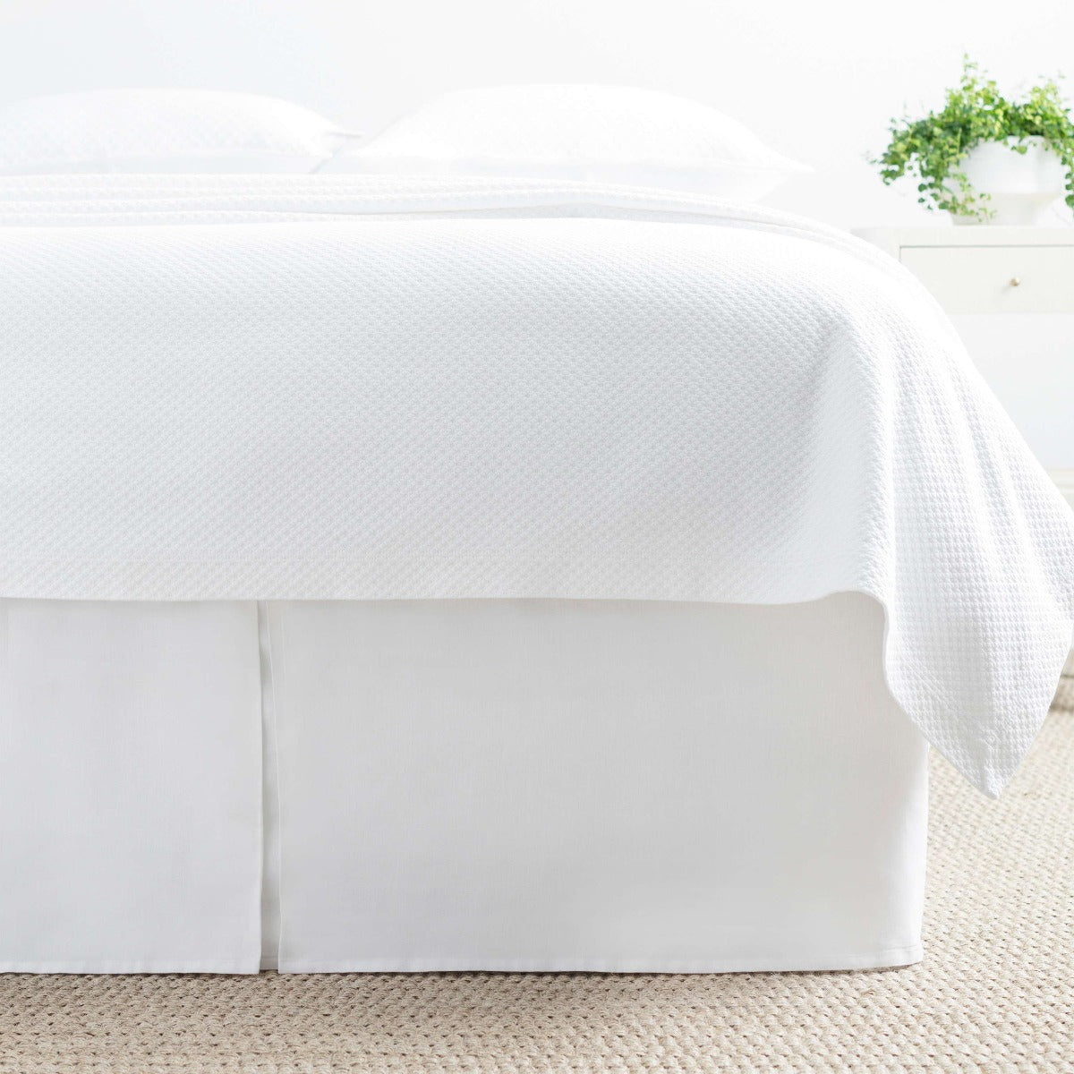Lush Linen White Bed Skirt styled with white bedding. Styled view.