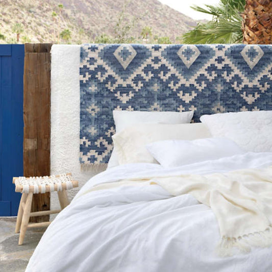 Lush linen bedding in the desert. Styled view.