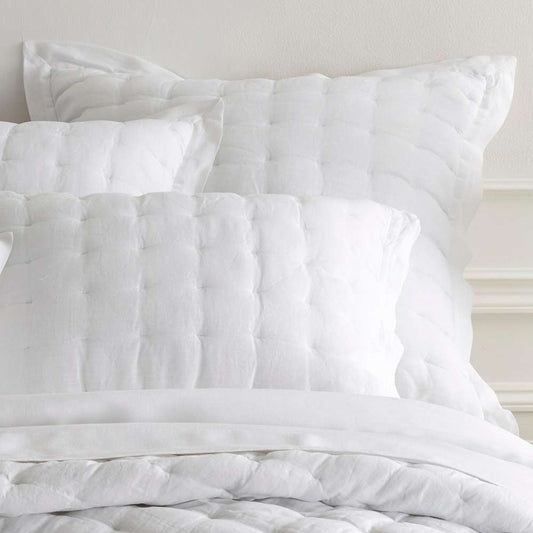 Lush Linen White Puff Sham styled with white bedding. Styled view.