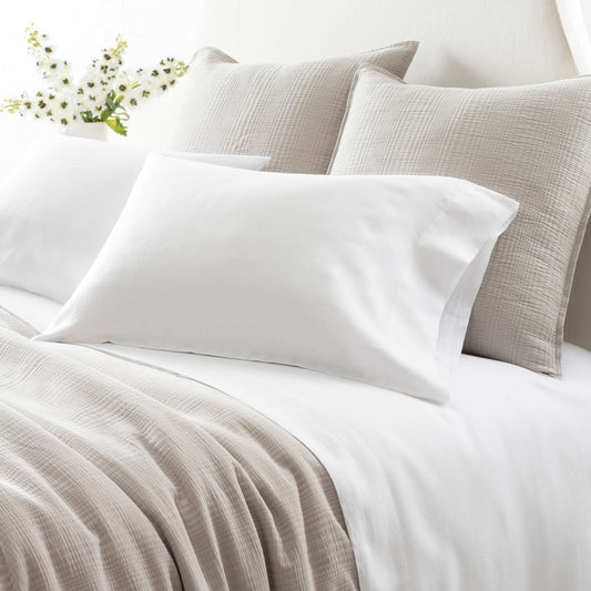 Lush Linen White Sheet Set styled with grey bedding. Styled view.