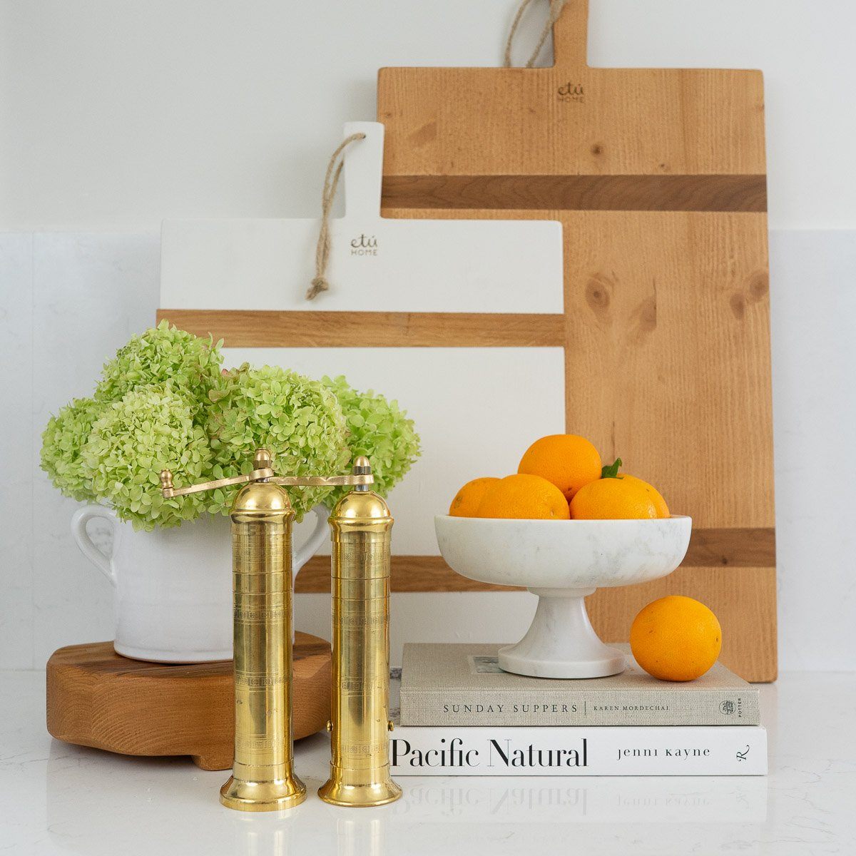 Marble Pedestal Bowl styled with kitchen decor on books. Styled view.