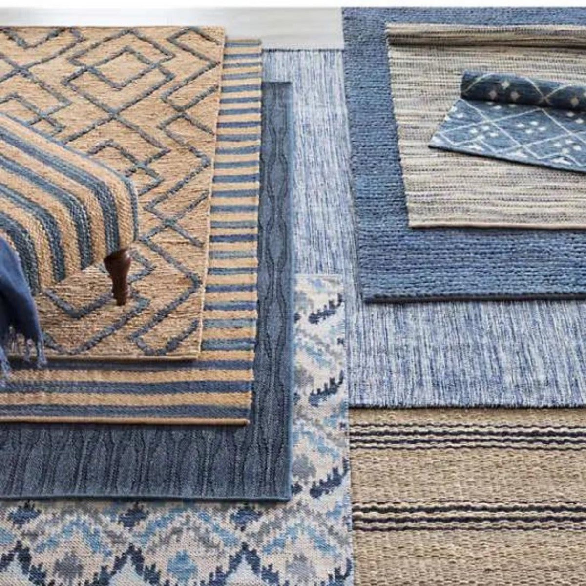 Marco Navy Jute Soumak Woven Rug styled with blue rugs. Styled view.