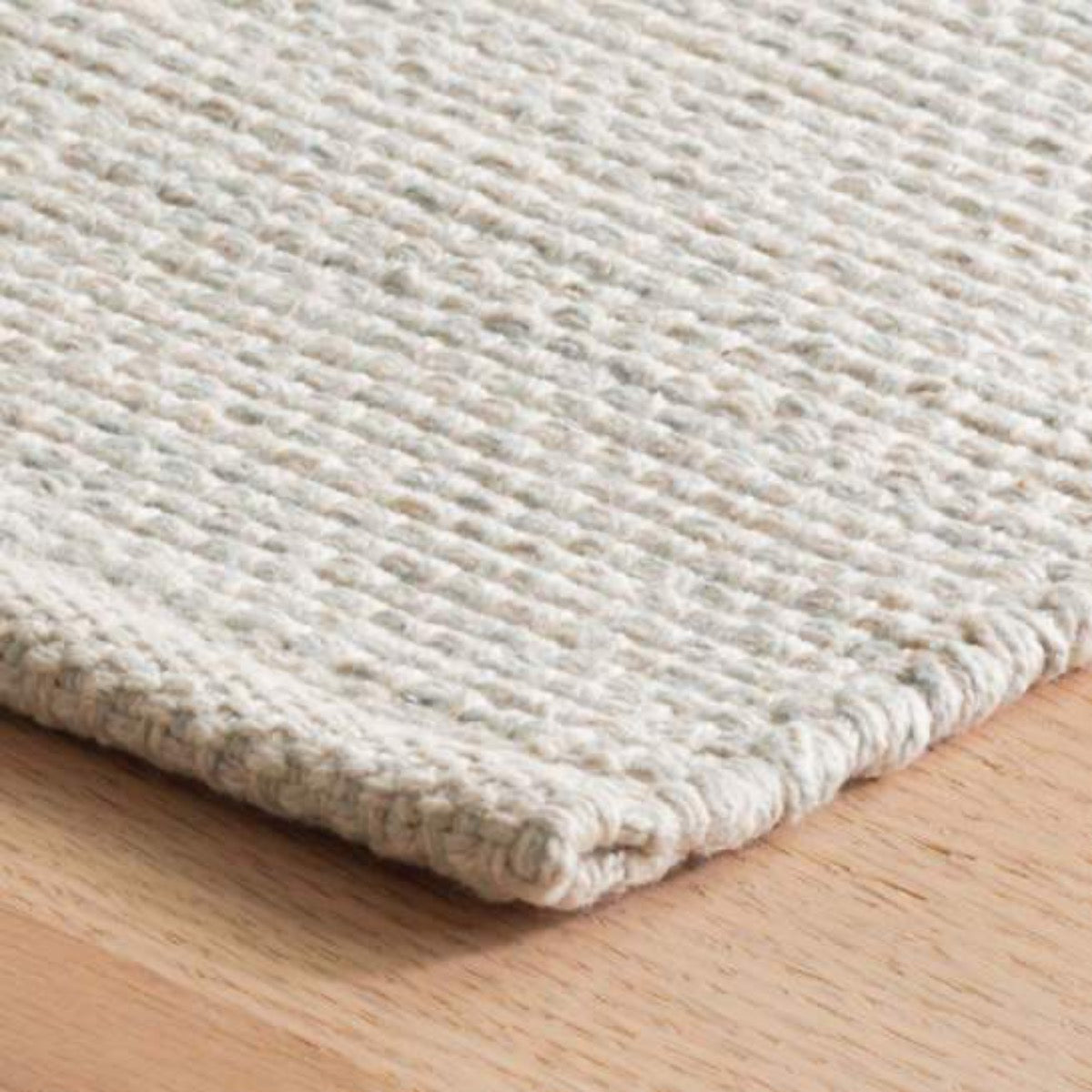 Marled Light Blue Woven Cotton Rug corner detail. Close-up detail view.