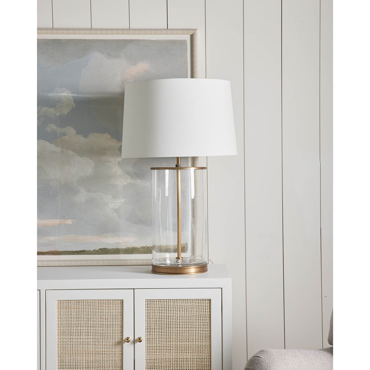 Magelian Glass Table Lamp styled on a white table with artwork. Styled view.