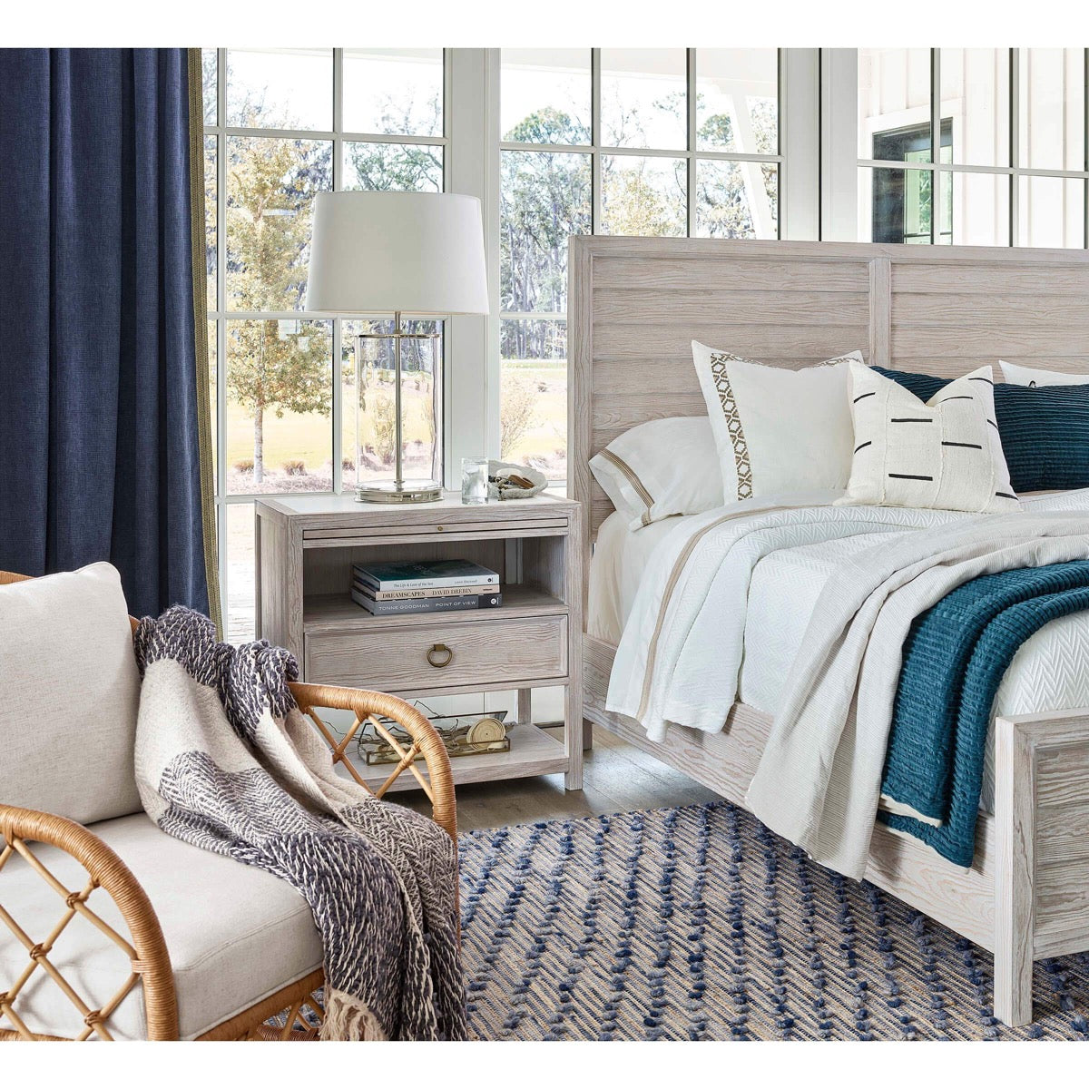 Magelian Glass Table Lamp styled on a rustic bedside table with light linens. Styled view.