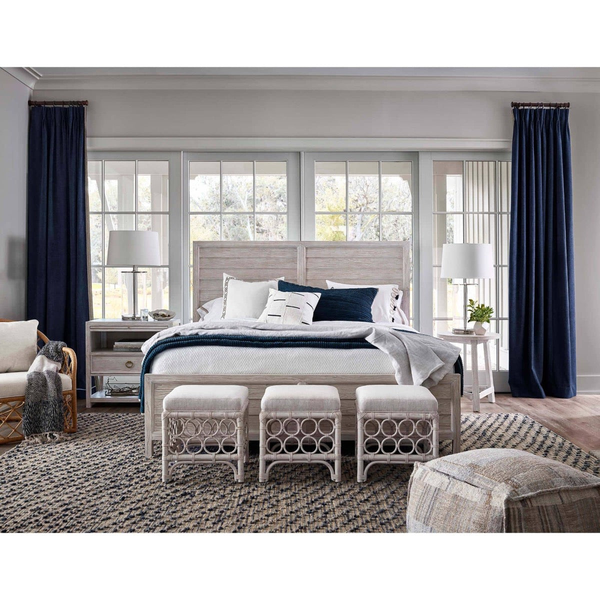 Magelian Glass Table Lamp styled in a light rustic bedroom with blue accents. Styled view.