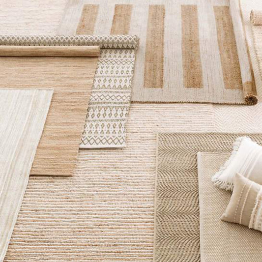 Milo Ivory Woven Jute/Cotton Rug styled with neutral rugs. Styled view.