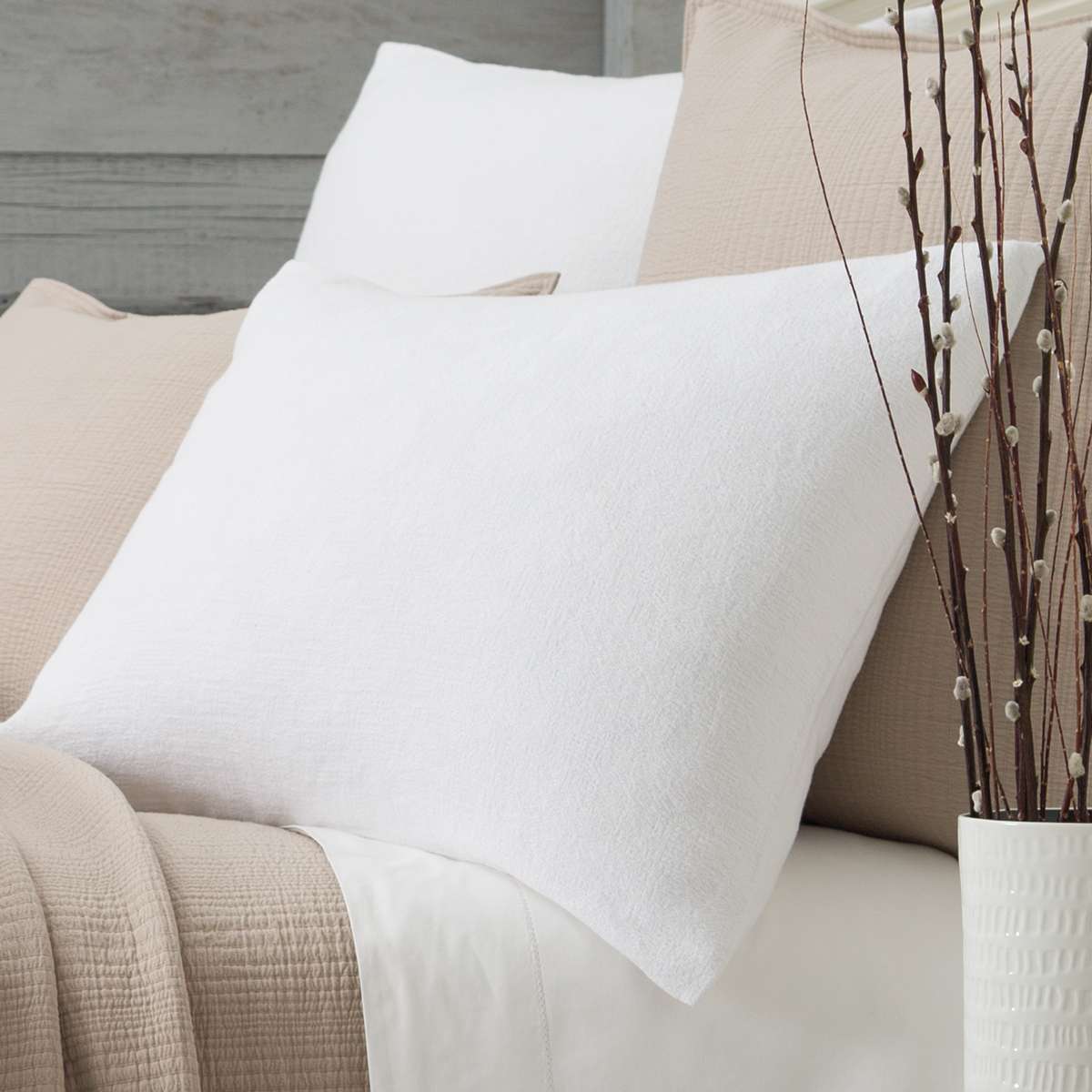 Montauk White Sham styled with neutral bedding. Styled view.