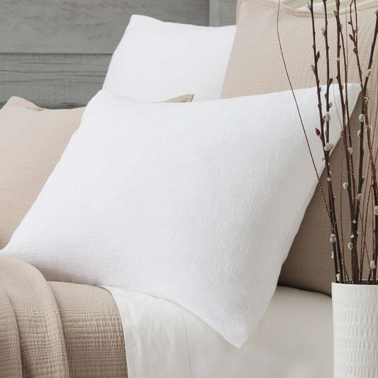 Montauk White Sham styled with neutral bedding. Styled view.