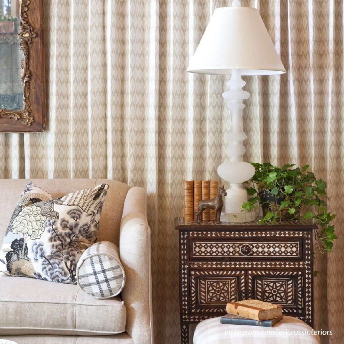 Nottingham Alabaster Table Lamp styled on a side table with greenery and decor in a living room. Styled view.