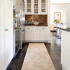 Ojai Wheat Loom Knotted Cotton Rug as a runner styled in a white kitchen. Styled view.