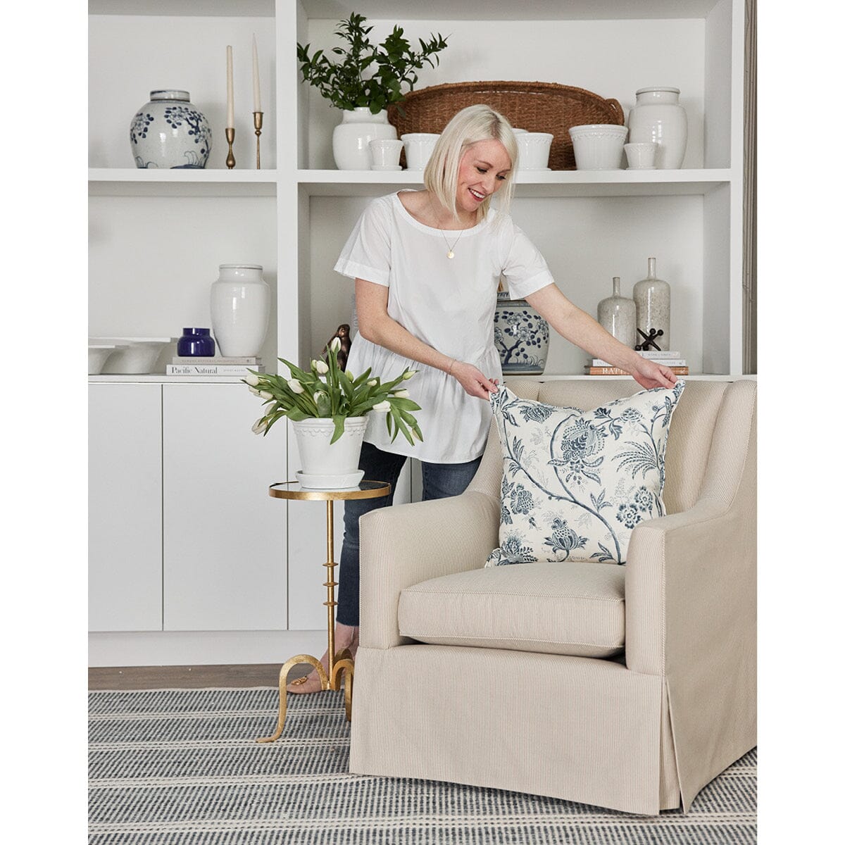 Owen Chair styled with blue pillows, blue rug and blue decor. Styled view.