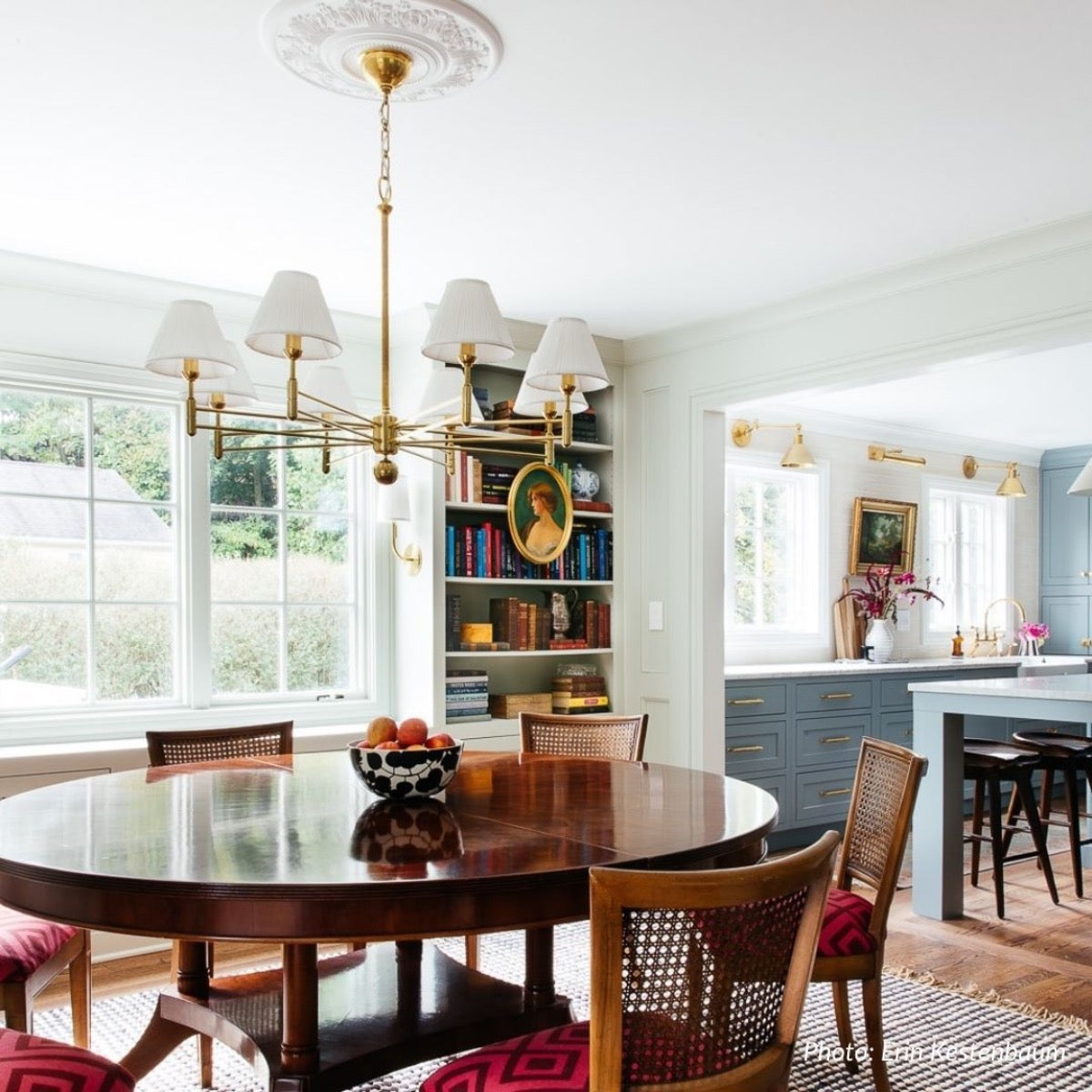 Oxford Brass Chandelier styled over a dark woos dining table. Styled view.