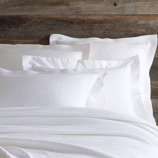 Petite Trellis White Matelasse sham styled with white bedding. Styled view.