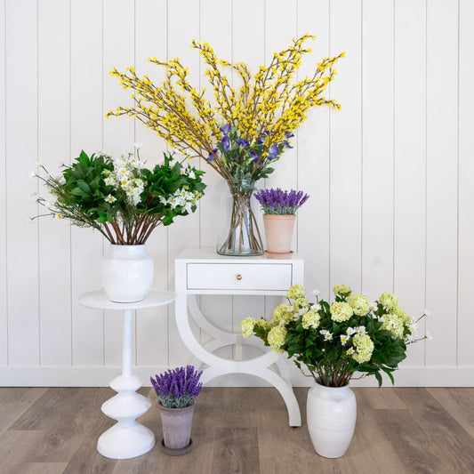 Piper Table styled with vases and faux greenery. Styled view.