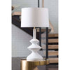 Piper Table Lamp styled on a gold table. Styled view.