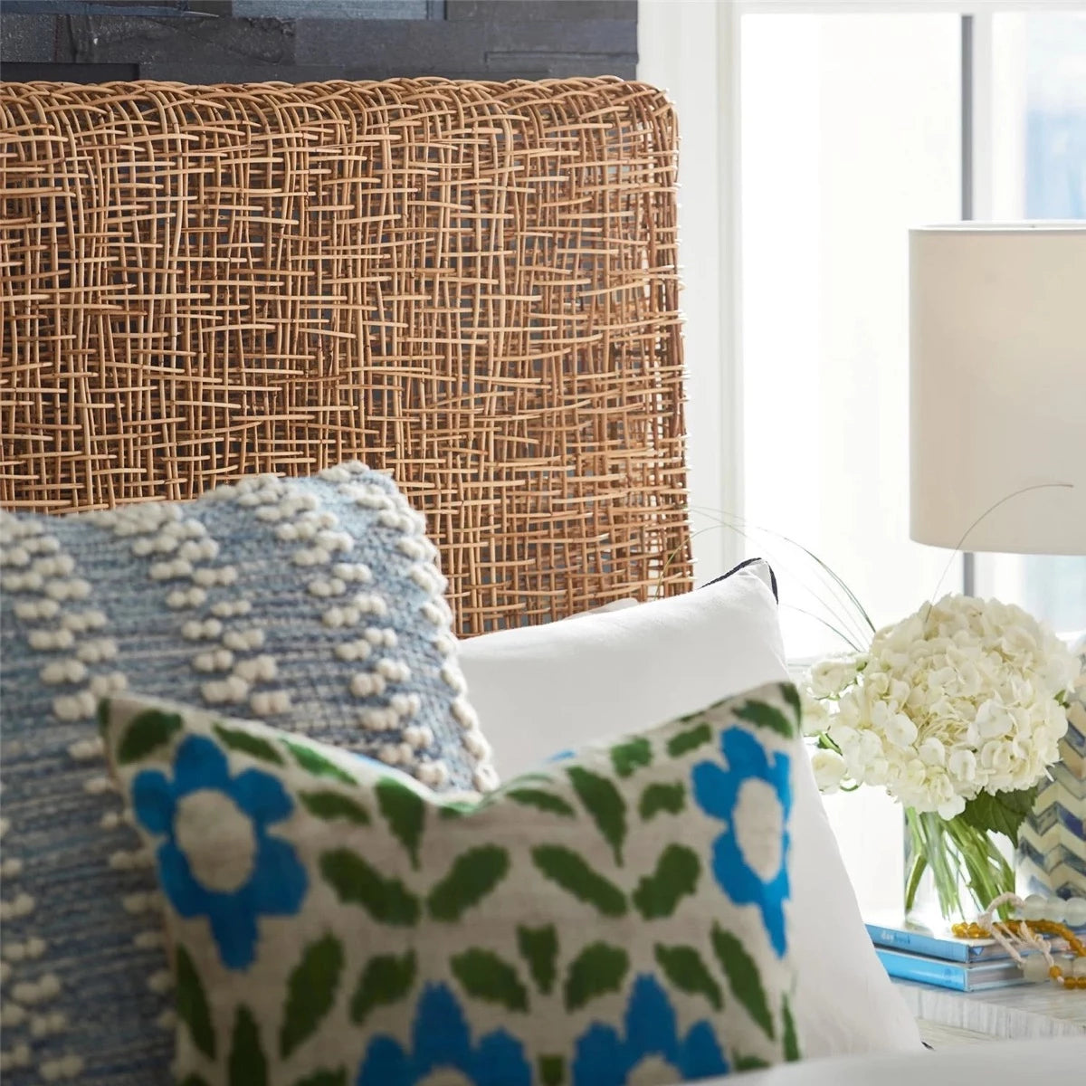 Riviera Queen Headboard styled with blue and green throw pillows. Styled view.