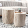 Rosalie Round Stump styled in a neutral living room with coffee table books. Styled view.