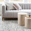 Rosalie Round Stump styled in front of a grey sofa on a wool rug. Styled view.