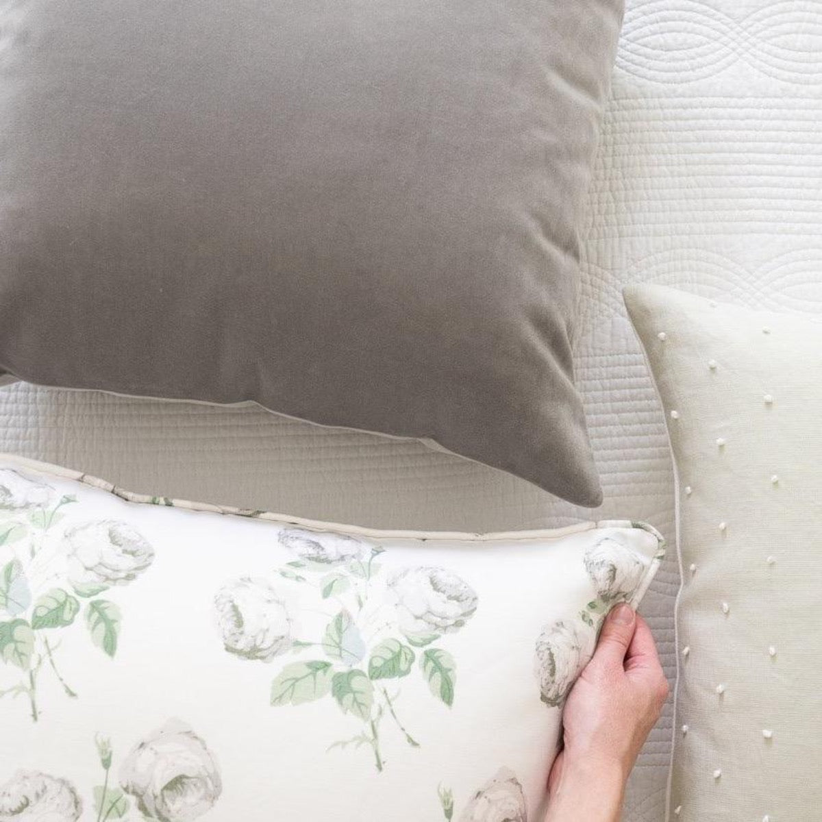Royal Velvet Lumbar Pillow - Dove Grey styled with a floral pillow. Styled view.