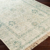 Sage Rug styled on dark wood floor. Styled view.