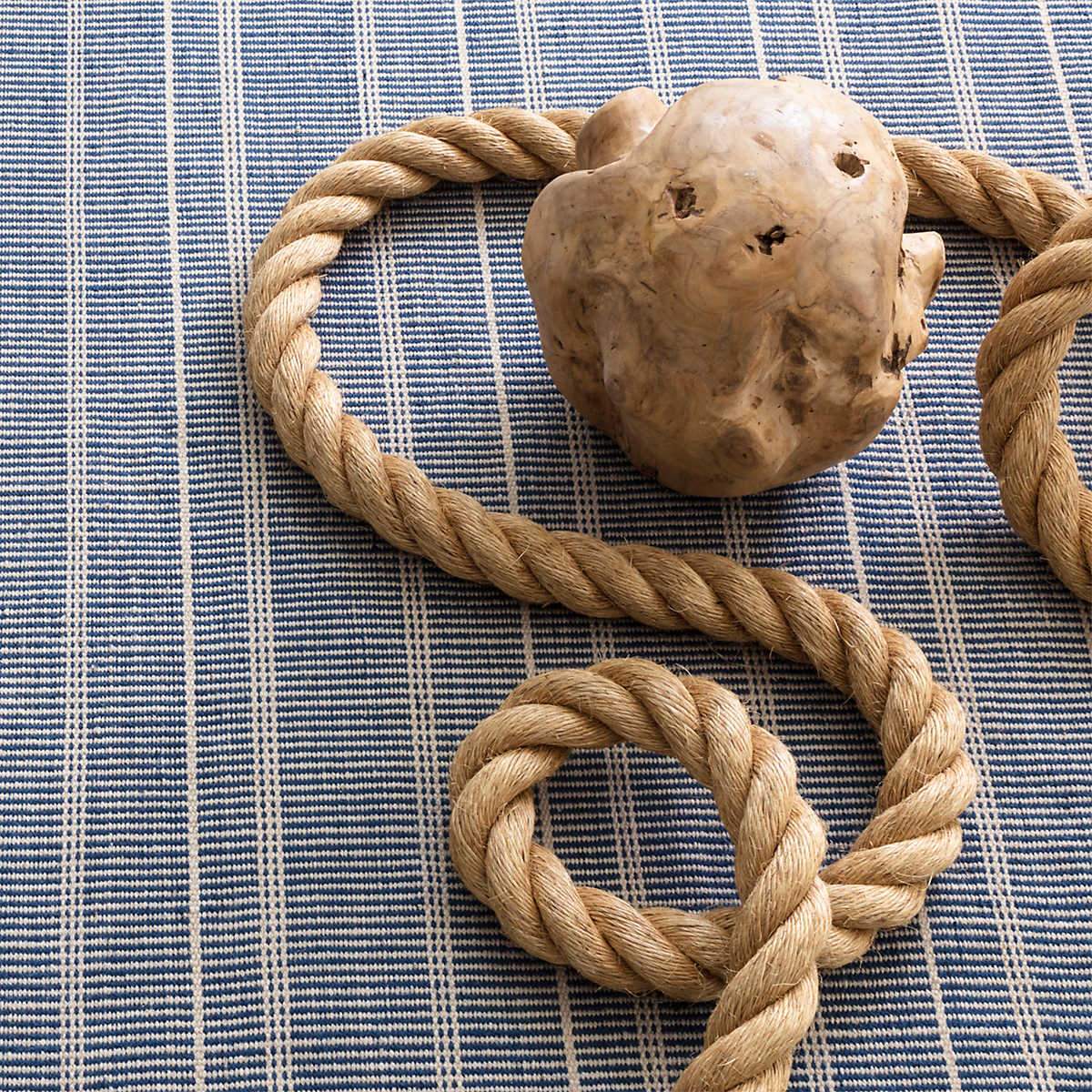 Samson Navy Indoor/Outdoor Rug styled under neutral decor. Styled view.