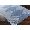 Sedona Outdoor Rug styled over dark wood floor. Styled view.