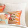 Seychelles Dove White Quilted Sham styled with orange pillows. Styled view.