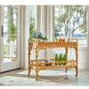 Tanner Rattan Bar Cart styled with drinks in front of a coastal view. Styled view.