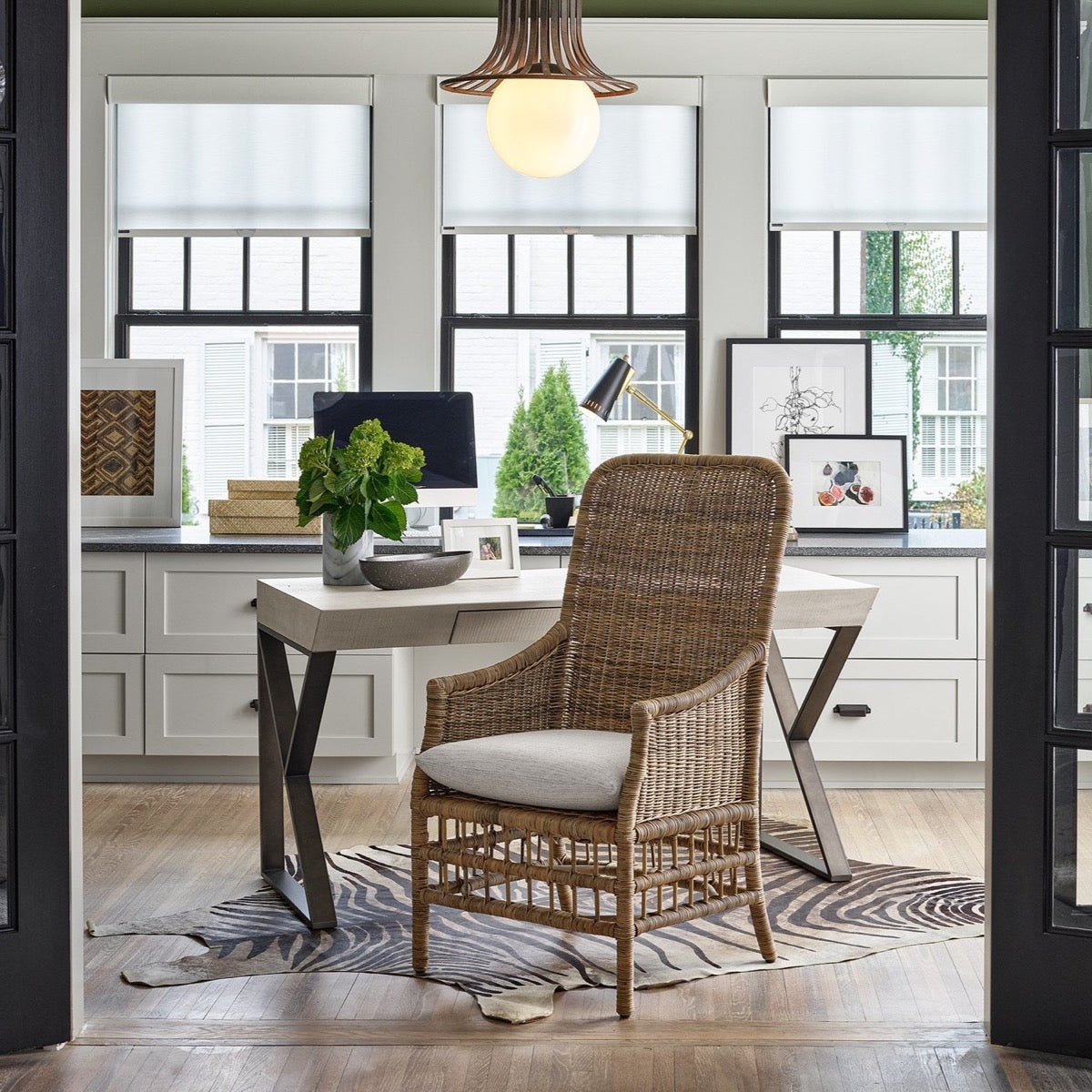 Taylor Arm Chair styled in an office space with desktop and greenery. Styled view.