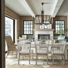 Taylor Arm Chair styled with white dining chairs and matching table in a dining room. Styled view.