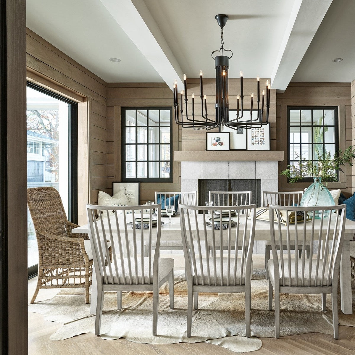 Taylor Arm Chair styled with white dining chairs and matching table in a dining room. Styled view.