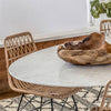 Trumpet Dining Table Oval with Marble Top - Small styled with wood bowl and chairs on a fluffy rug. Styled view.