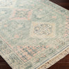 Victoria Rug styled over dark wood floor. Styled view.