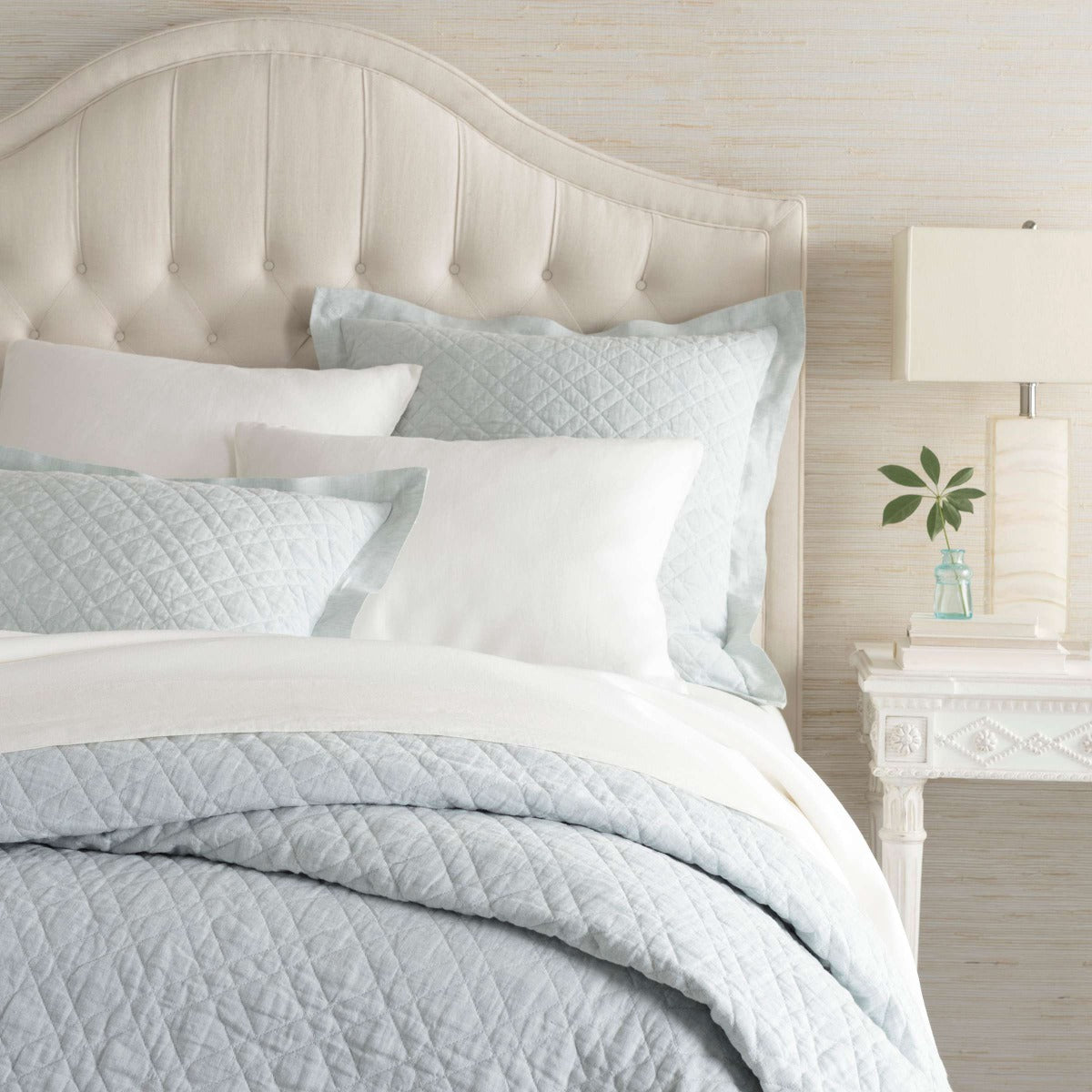 Washed Linen Sky Quilt styled with white sheets. Styled view.