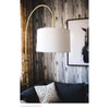 Brighton Floor Lamp styled above a navy sofa with artwork. Styled view.
