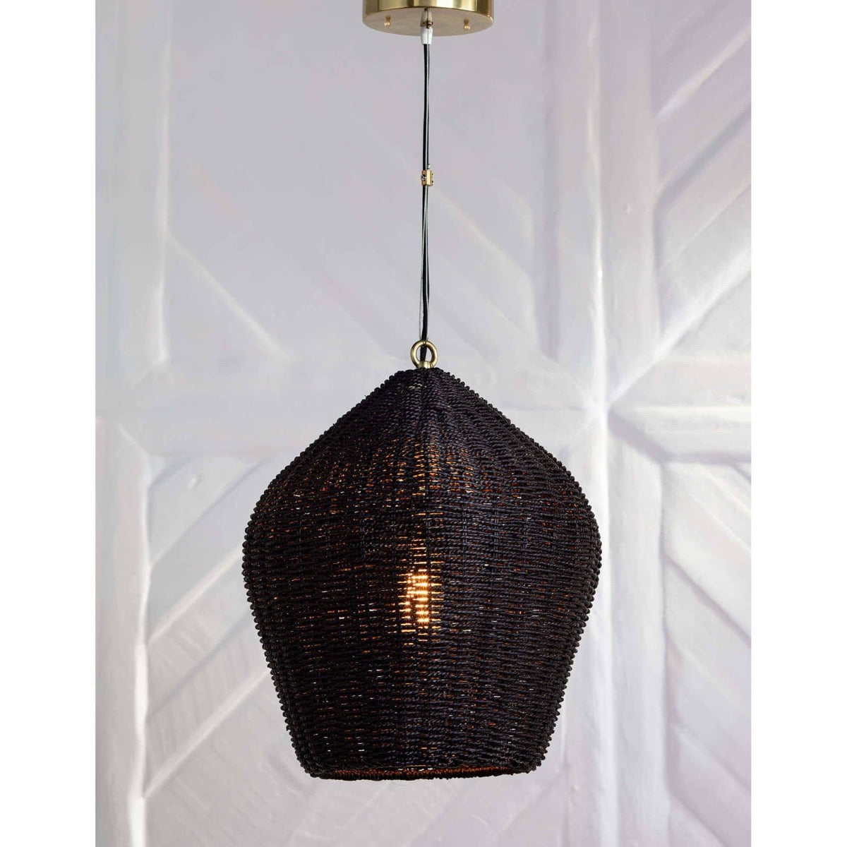 Georgian Pendant styled again a textured white wall. Styled view.