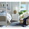 Georgian Table Lamp styled on a white bedside table with neutral bedding. Styled view.