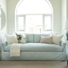 Light blue sofa with decorative pillows in a bright living room