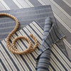 Archer Navy Woven Cotton Rug styled with blue rugs. Styled view. 