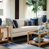 Ashley End Table styled beside a white sofa with blue accents in a living room. Styled view.